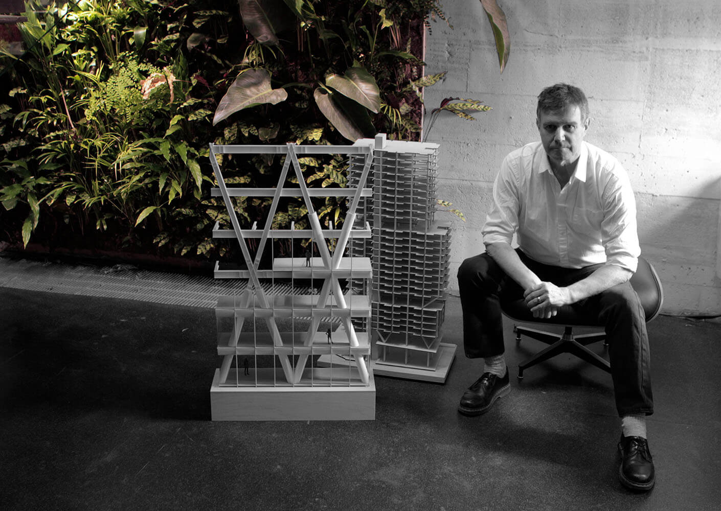Portrait of Adrian next to a large physical project model