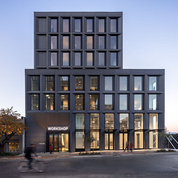 A photo of the front elevation of 161 East 4th Avenue, known as the 'Workshop' with pedestrians and a cyclist.